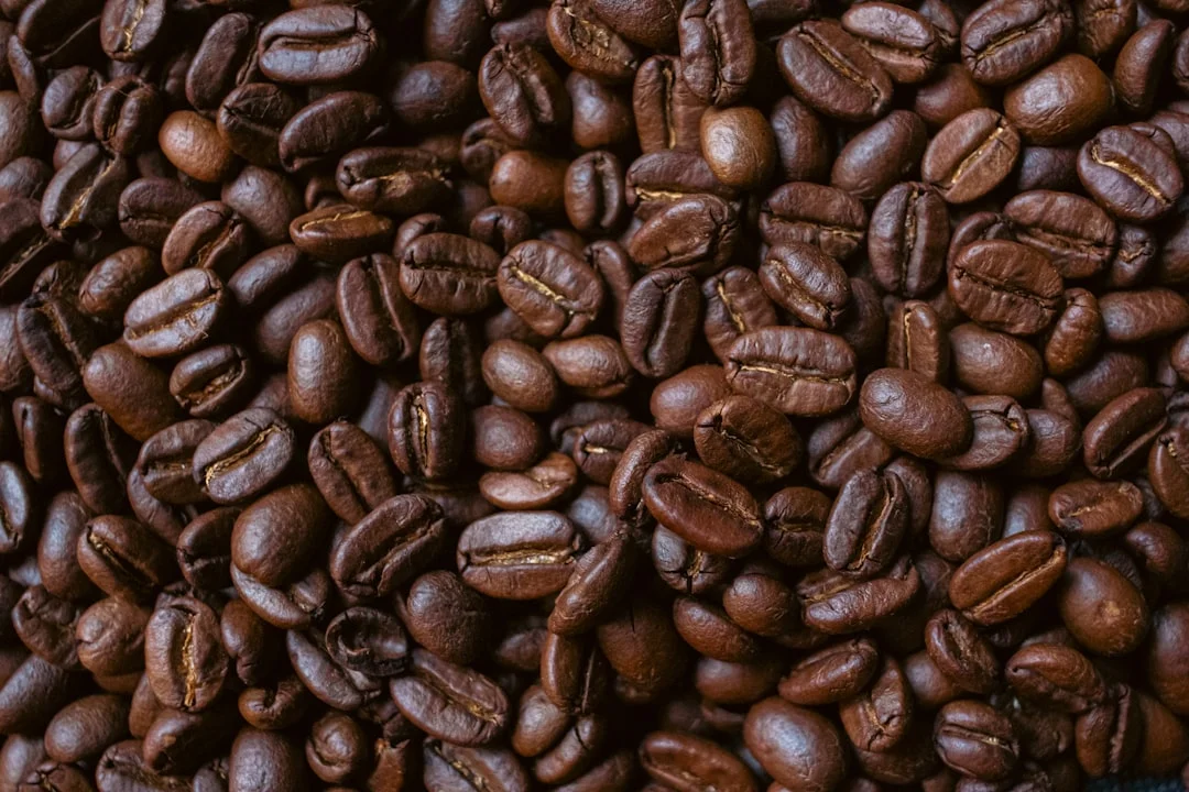 Roasted coffee beans fill the frame.