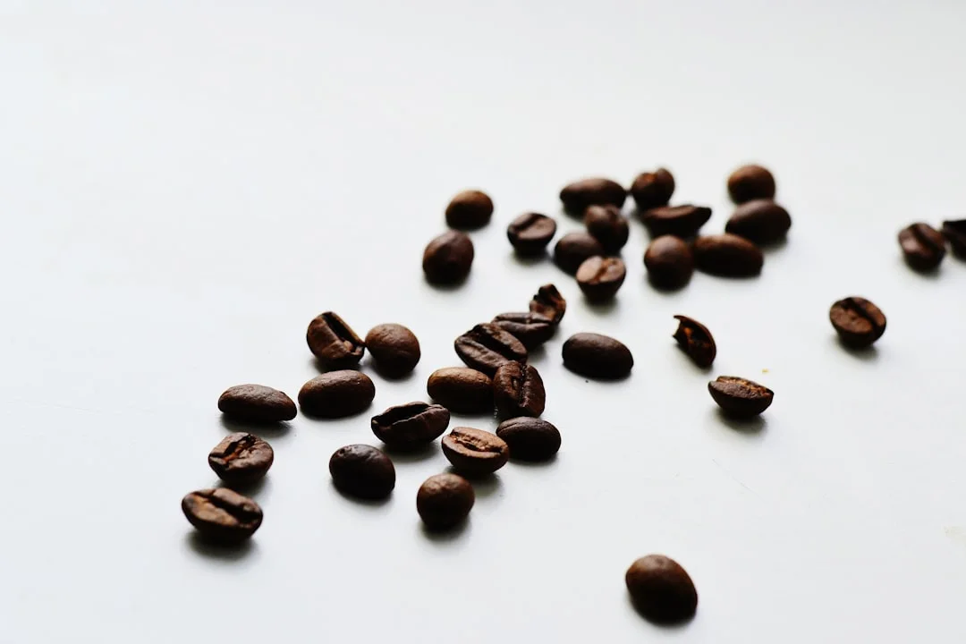 brown coffee beans on white surface